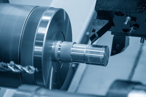 The,cnc,lathe,machine,forming,cutting,the,metal,shaft,parts.