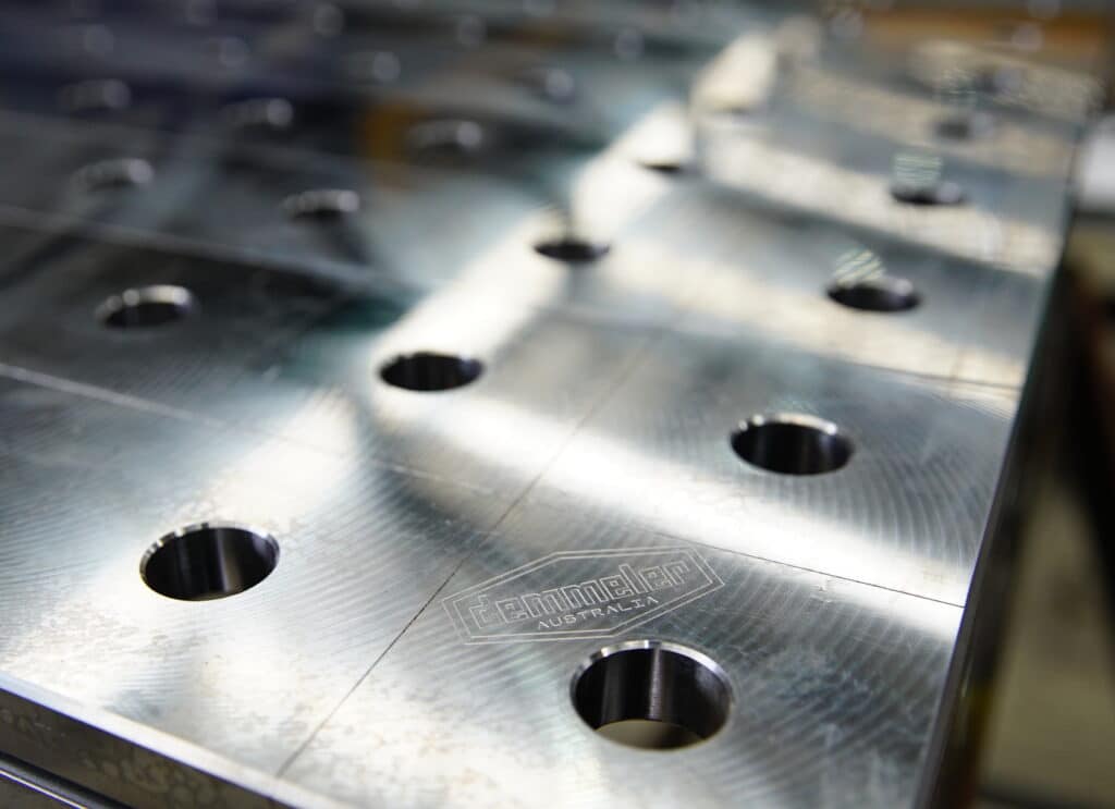 Close up of a welding table showing bore holes